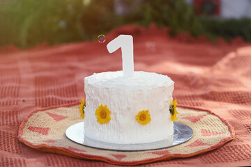 Outdoor cream smash cake for one year old child