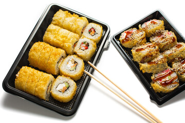 sushi set in an open black plastic bag with two chopsticks. White background