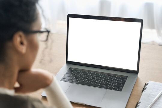 Over shoulder closeup view of female student wearing glasses businesswoman looking at empty blank mockup screen for advertising, having virtual videoconference. Remote e learning online work concept.