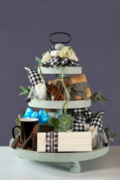 Father's Day or masculine birthday. On-trend farmhouse aesthetic three tiered tray decor filled with gifts, cute black plaid gnomes, and farmhouse style stack of books mockup. Vertical.