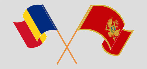 Crossed and waving flags of Romania and Montenegro