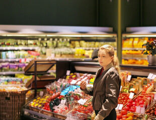 Woman buying fruits and vegetables at the market
