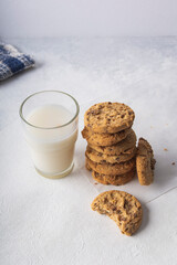 tasty cookies with chocolate chips and a glass of milk