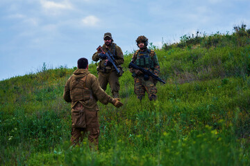 Armed military opponents negotiate on a hillside