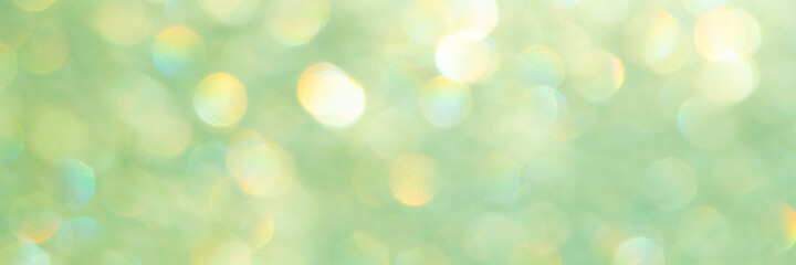 bright glitter background: bokeh effect from many colored lights on frozen glass, toning