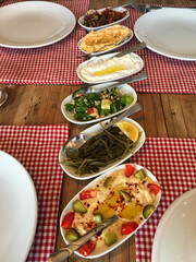 Turkish mezes appetizers of carrot with yoghurt.Turkey. Aegean appetizers in small plates on the table . Turkish and Greek dinner meze table. Turkish Cuisine Cold Appetizers appetizers with olive oil