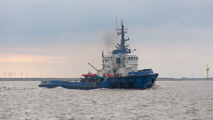 vessel departing harbor at sunset