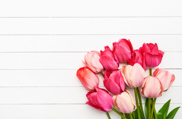 Bright pink tulips bouquet on a white wooden background. Valentines Day, Mothers Day, Birthday concept