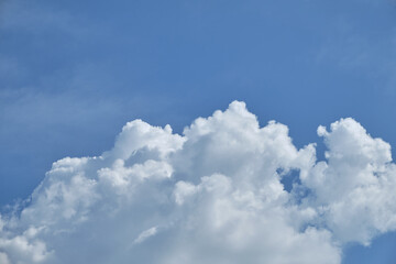 White clouds over blue sky horizontal with copyspace