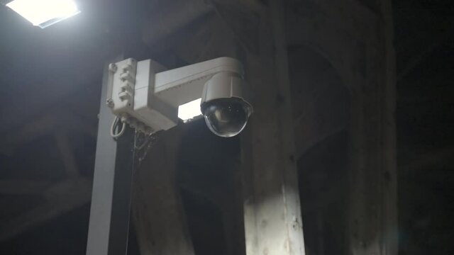 Panning A Spherical Mounted Security Camera Located High On A Pole And Between Two Square Lights - Berlin, Germany