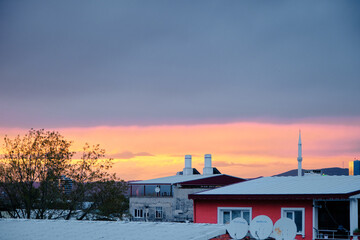 Sunset sky in cloudy day in Bursa with houses and roofs with minaret of a local mosque and radio stations. Bursa Turkey 4.4.2021.
