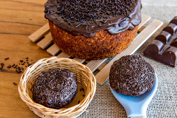 Chocolate cake and brigadeiro candy on the table.