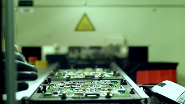 Worker Hand Holding Bar Code Scanner over Printed Circuit Boards at Computer Manufacturing Plant. Close Up. 4K Resolution.