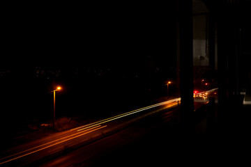 Night photo with long exposure with street lamp and cars front and rear lamps reaminings on the photo.