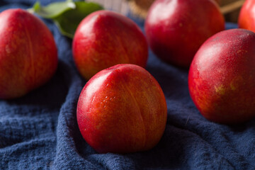 Group of whole nectarine fruits on wood background