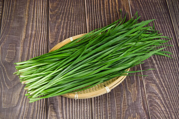 Fresh Chinese chives,Garlic chives on wooden background
