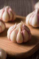Garlic Cloves and Garlic Bulb on vintage wood background