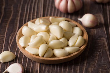 Garlic Cloves and Garlic Bulb on vintage wood background