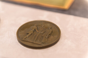 Old medal about contractual relations. Copper Medal close-up.