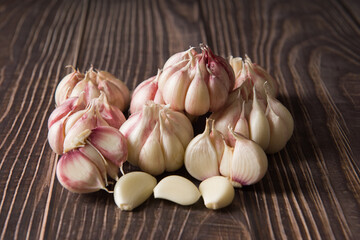 Garlic Cloves and Garlic Bulb on vintage wood background