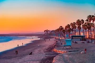  A Oceanside sunset at the beach draws people to it to walk and relax and the ocean shoreline. © Patricia E. Thomas