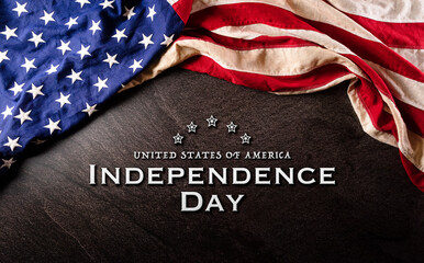 Fototapeta na wymiar Happy Independence day: 4th of July, American flag on dark stone background with the text.