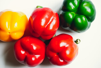 Bell peppers on a white background, red, yellow, green. Healthy eating, produce, organic, fresh, food.