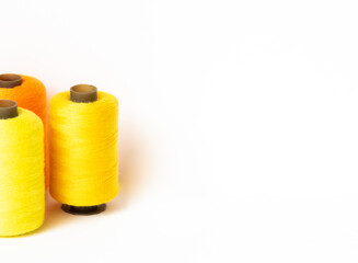 spools of thread on a white background, copy space, leisure time.