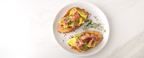flat lay plate of avocado and bacon toasts