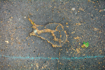 Bumpy road with chalk blue line marking of gray cracked asphalt. Travel concept