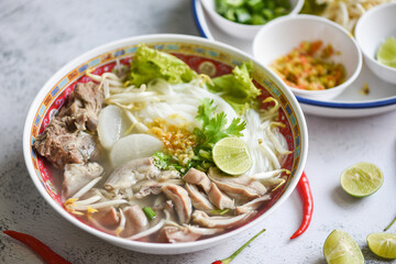 Thai rice vermicelli noodle with spicy soup and fresh vegetable set with lemon sprouts bean pepper chili sauce Thai traditional menu food, Noodle soup bowl