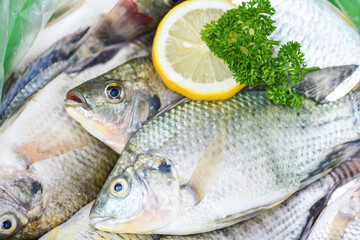 Fresh Tilapia fish freshwater for cooking food with parsley and lemon, Raw tilapia from farm