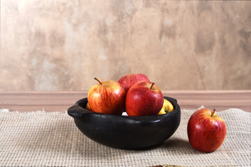 natural and healthy tropical fruit apple in the bowl on the table on blurred texture background