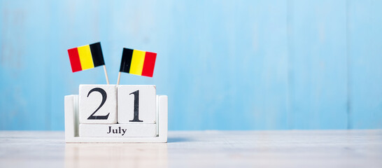Wooden calendar of July 21th with miniature Belgium flags. Belgian National Day and happy celebration concepts