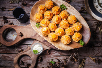 The cheese spread is ball-shaped, usually served at Christmas in the United States and Canada.

S