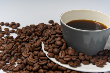 Fototapeta premium Coffee beans and coffee on a white background