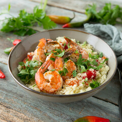 bowl of couscous with shrimps close-up