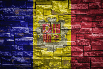 National flag of Andorra on stone  wall background.The concept of national pride and symbol of the country. Flag  banner on  stone texture background.