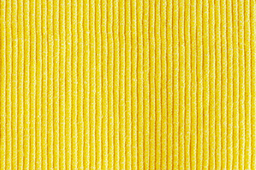Close-up of dense fabric.Textured illuminating yellow background.