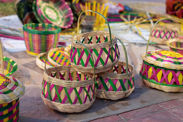 Beautiful handmade flower basket made by bamboo is displayed in a shop for sale in blurred background. Indian handicraft