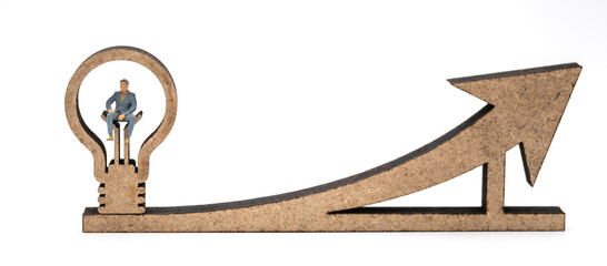 Business Financial and Idea Concept. Businessman miniature figure people sitting on wooden lightbulb icon on arrow chart on white background.