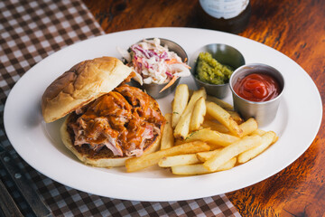pulled pork sandwich with coleslaw and French fries