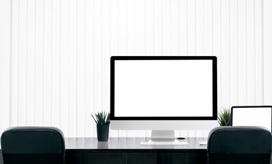 Blank screen monitor on counter table in modern office room with copy space.