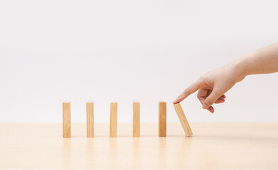 hand holding a jenga wooden block