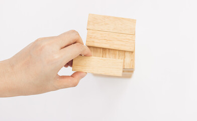 hand holding a wooden block
