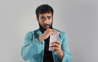 boy is not happy in showing his mobile in white background