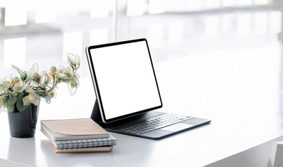 Fototapeta premium Mockup blank screen tablet with keyboard on white wooden table in modern office room.