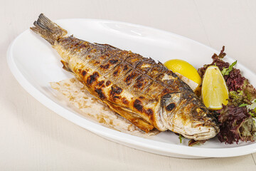 Grilled seabass fish served lemon