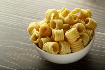 Indian snack foods- Homemade butter murukku, chakli served in ceramic bowl.