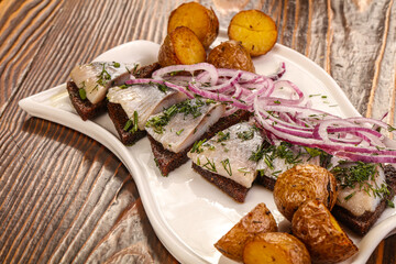 Herring snack with bread and potato